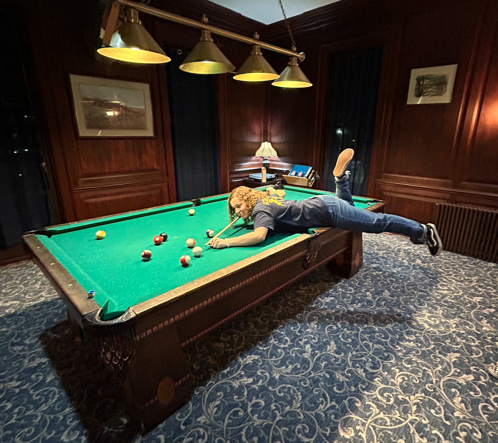 destiny lying on the pool table to get her shot